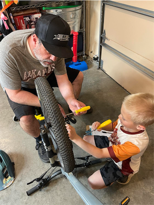 Brad and Michael working on a bike.